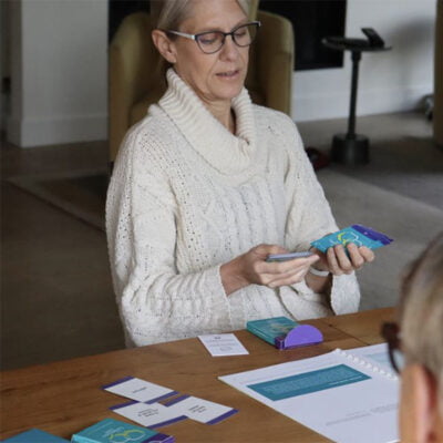 Focus on the Conversation Game - lady looking the Conversation Game cards